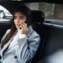 businesswoman sitting her car talking phone scaled webp 90x90